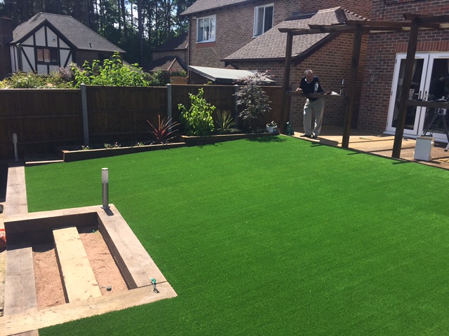 Bedding area with planted flowers behind sleeper wall